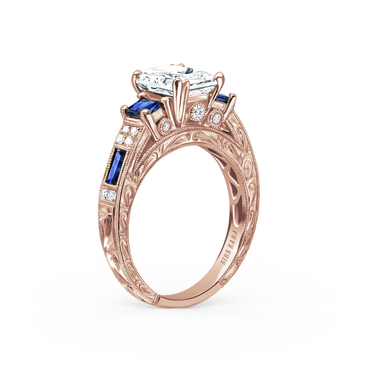 Angled view of deco three-stone engraved sapphire baguette diamond engagement ring.