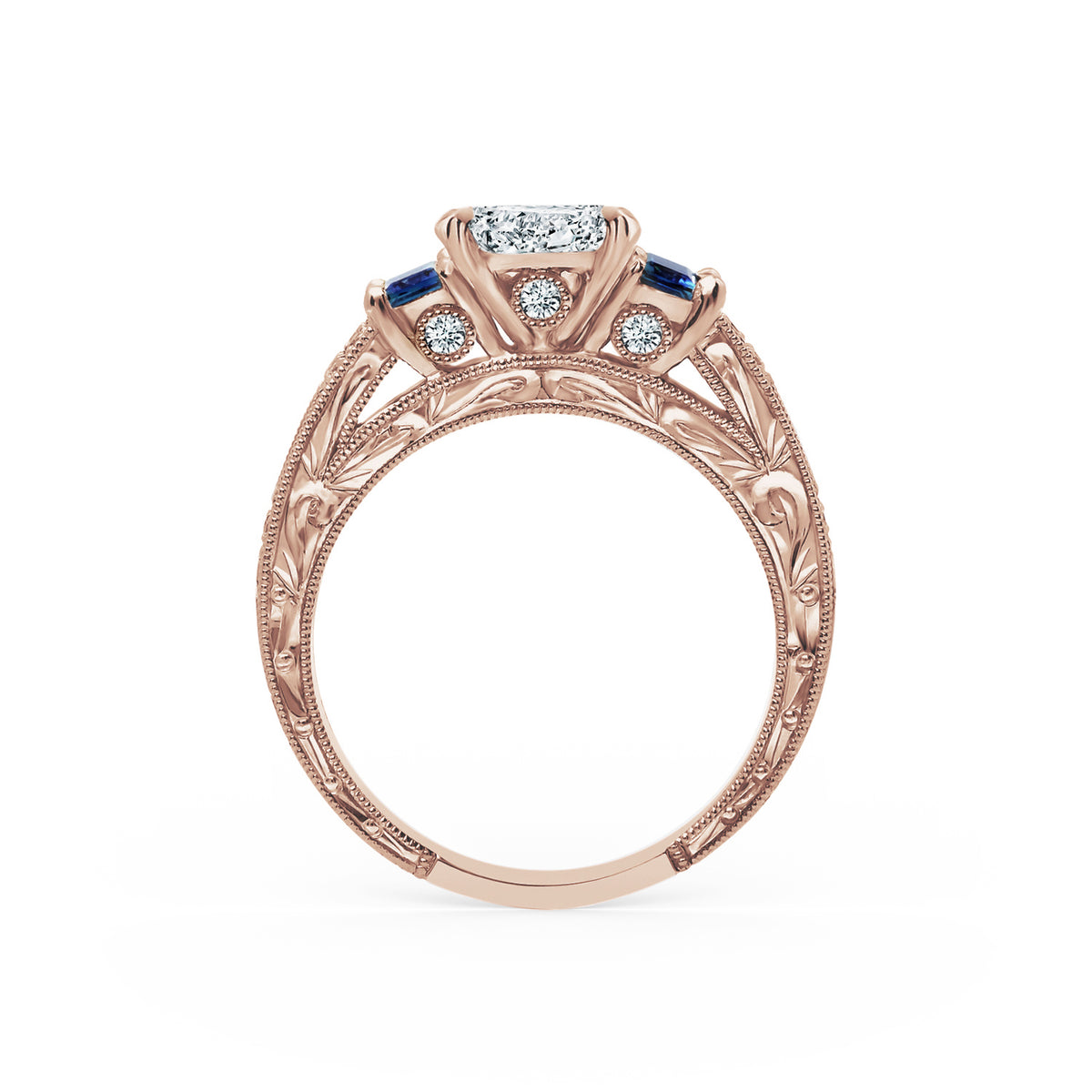 Side profile of deco three-stone engraved sapphire baguette diamond engagement ring.