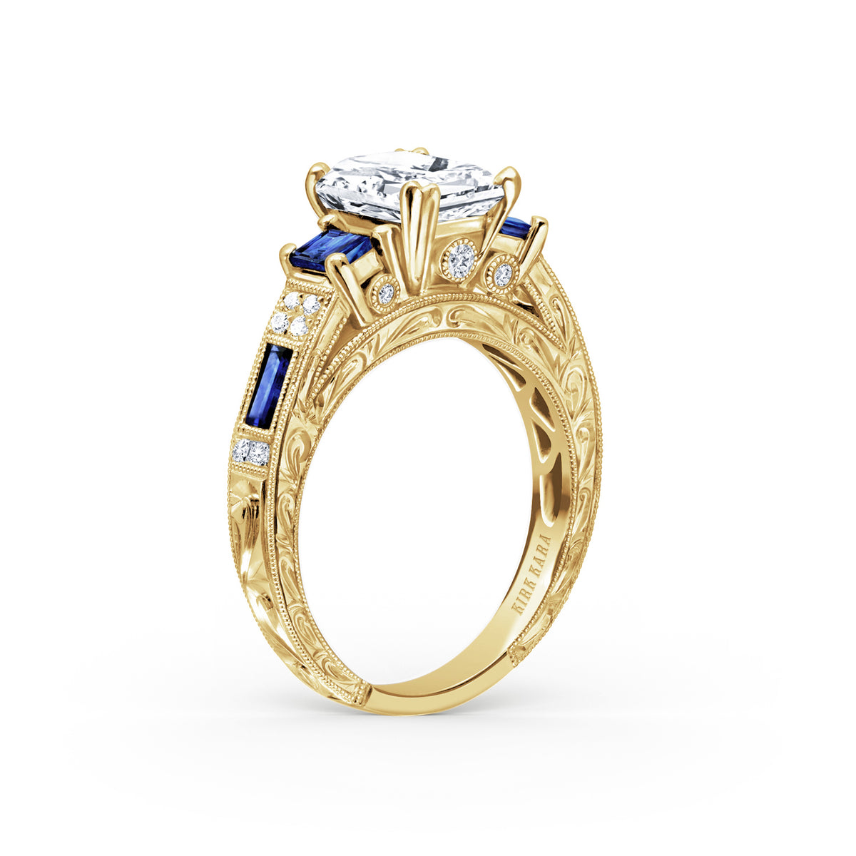 Angled view of deco three-stone engraved sapphire baguette diamond engagement ring.