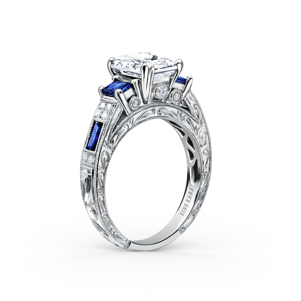 View of deco three-stone engraved sapphire baguette diamond engagement ring.
