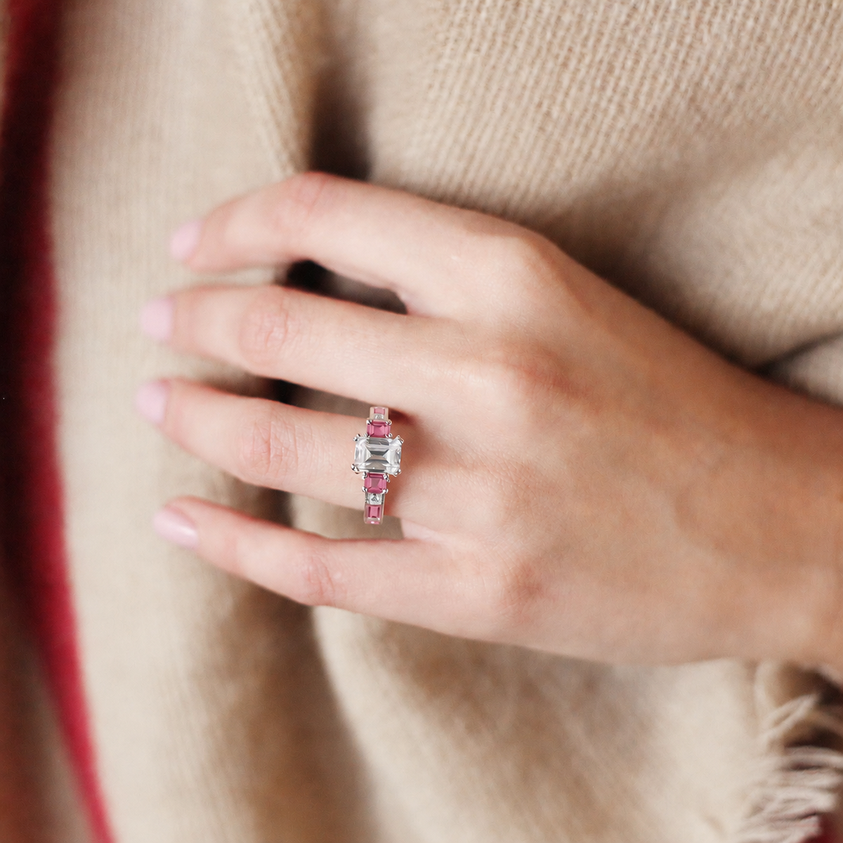 View of deco three-stone engraved sapphire baguette diamond engagement ring.