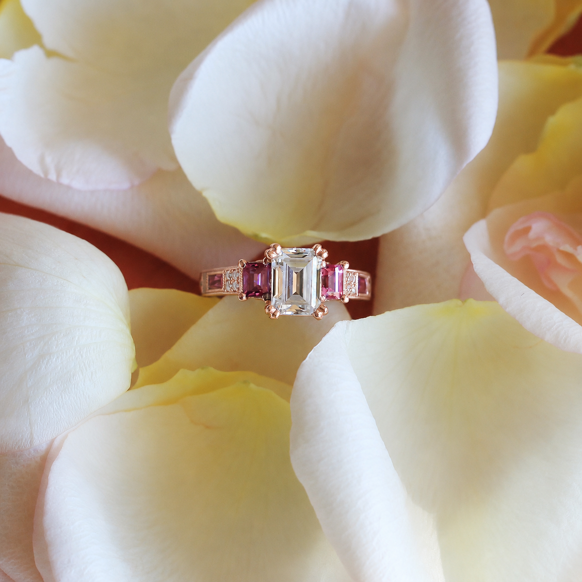View of deco three-stone engraved sapphire baguette diamond engagement ring.
