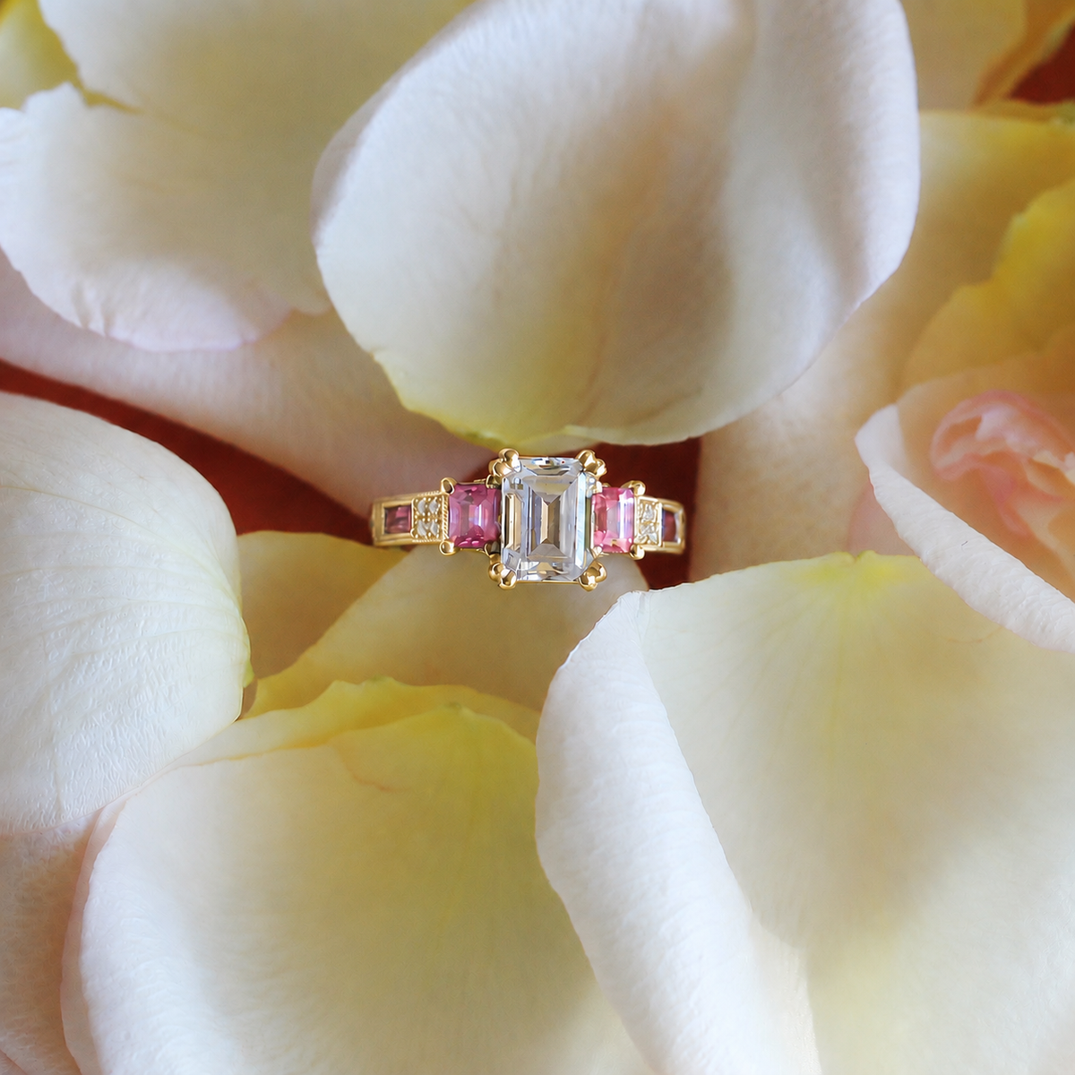 View of deco three-stone engraved sapphire baguette diamond engagement ring.